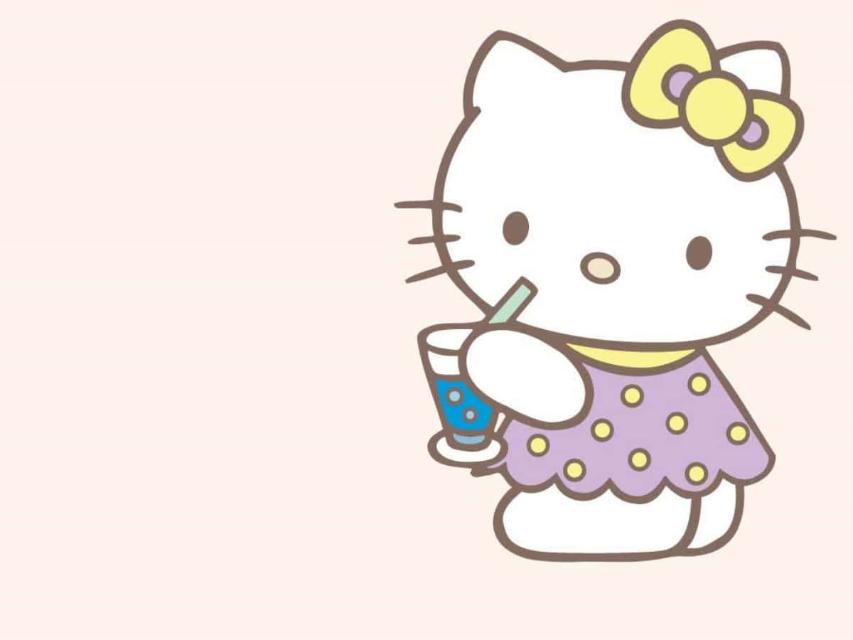 Hello Kitty nhâm nhi đồ uống bên laptop Hình nền