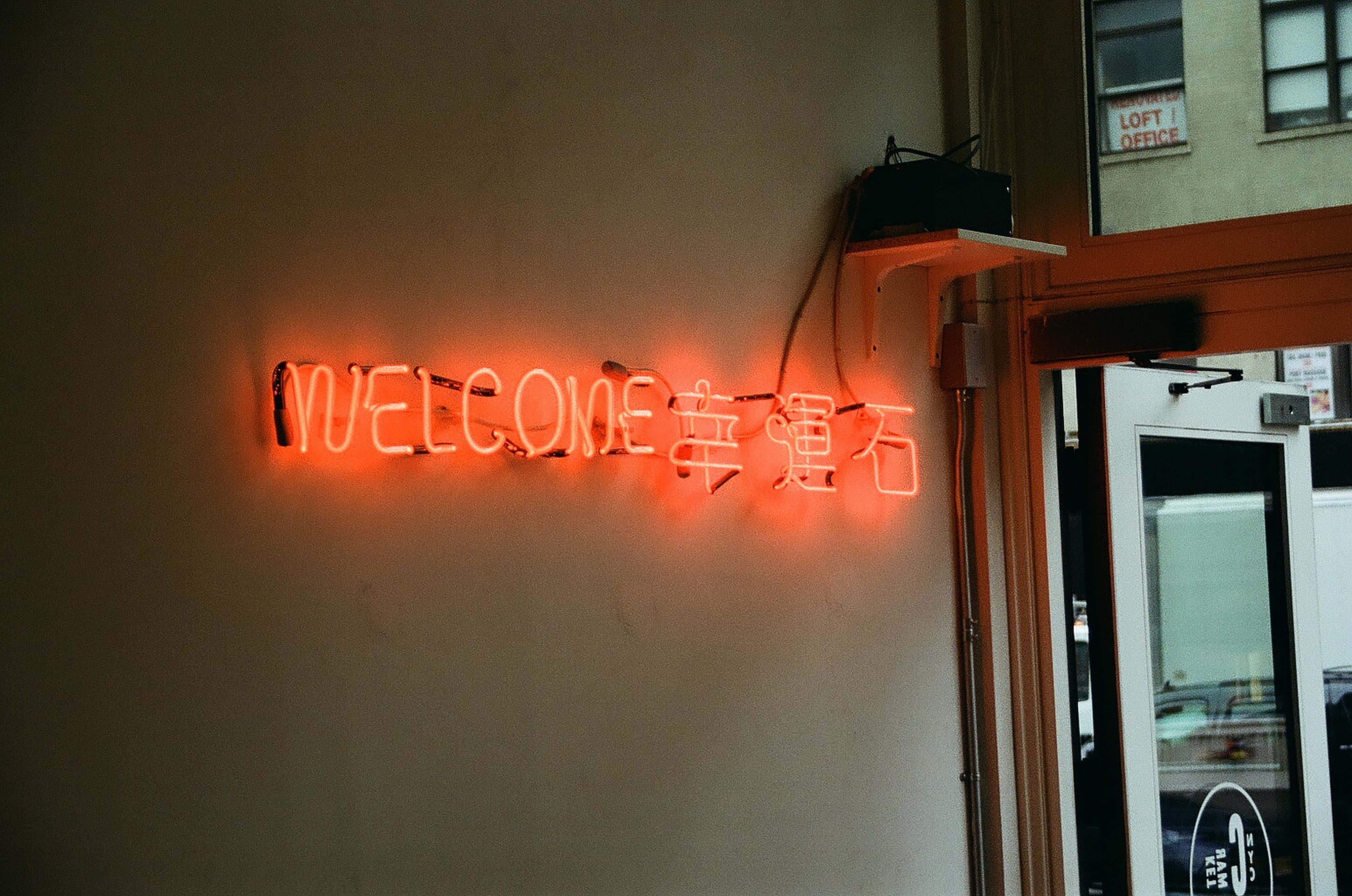 một bảng hiệu neon ghi chữ welcome trên tường Hình nền