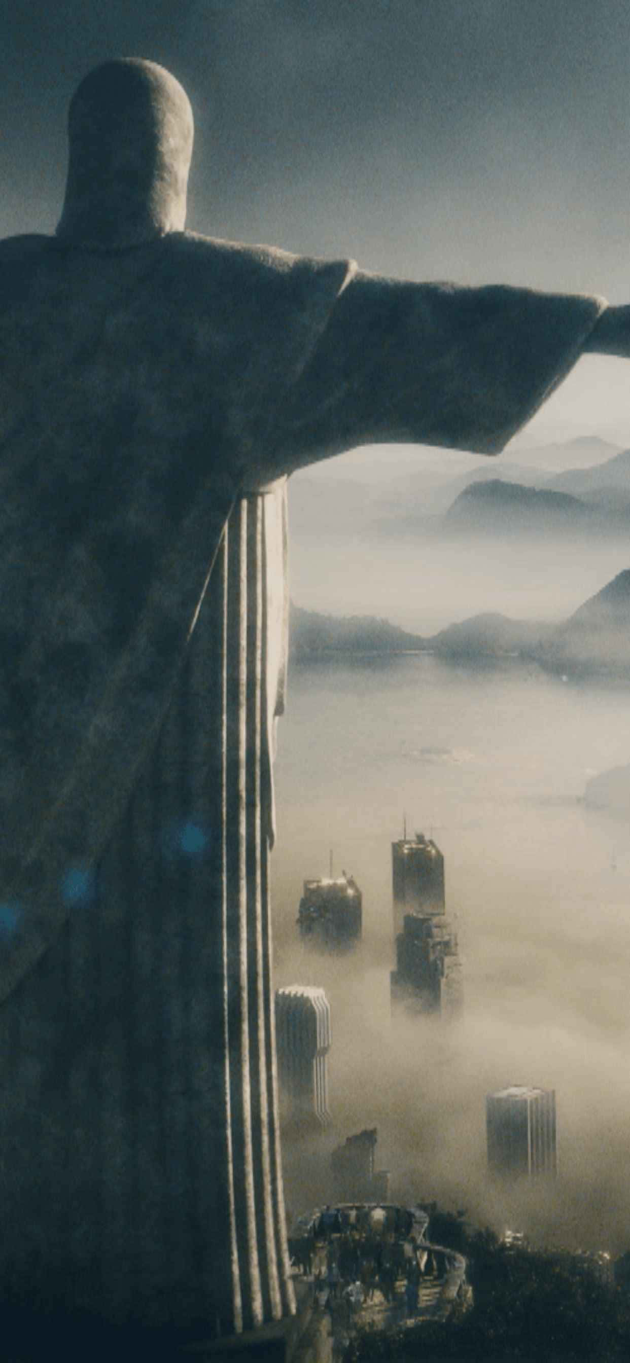 một bức tượng chúa với thành phố phía sau Hình nền