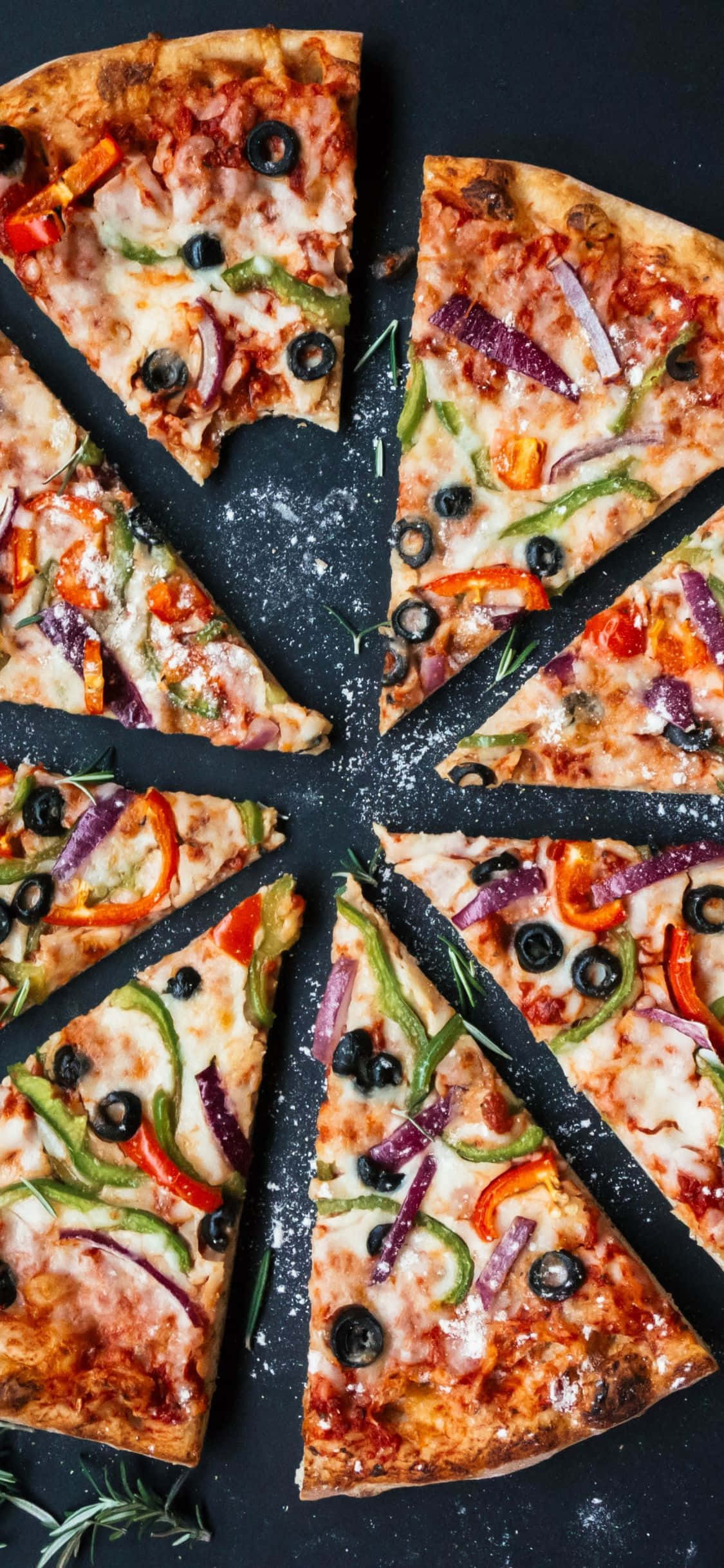 một chiếc pizza với rau củ và ô liu được cắt thành từng lát Hình nền