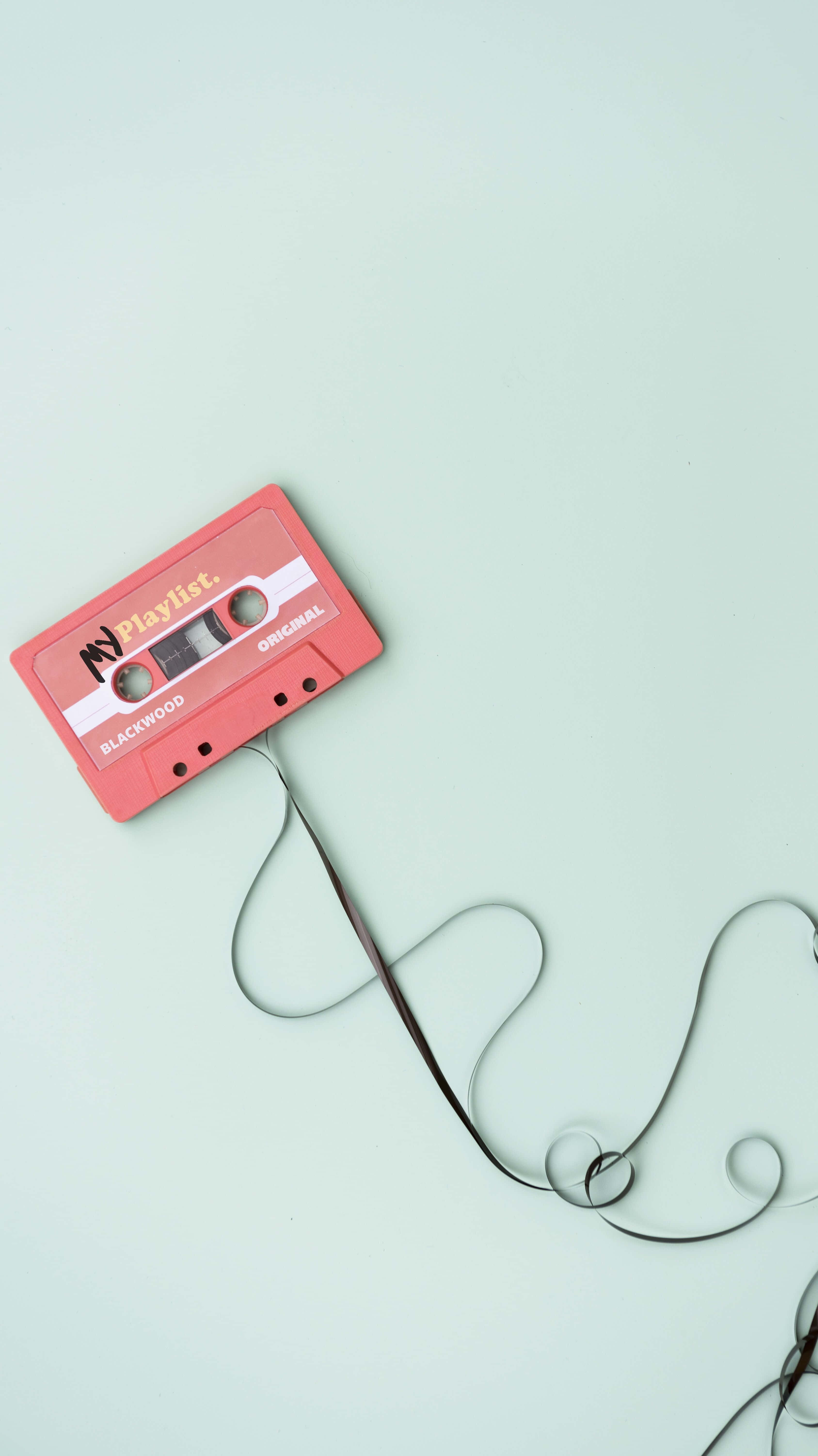Một cuộn băng cassette được nối với một sợi dây Hình nền