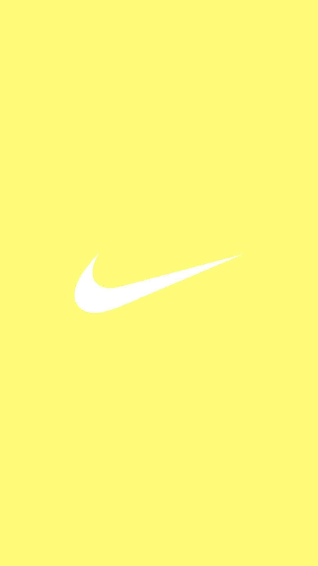Phong cách pastel vàng dễ thương đầy mê hoặc với biểu tượng Nike huyền thoại Hình nền