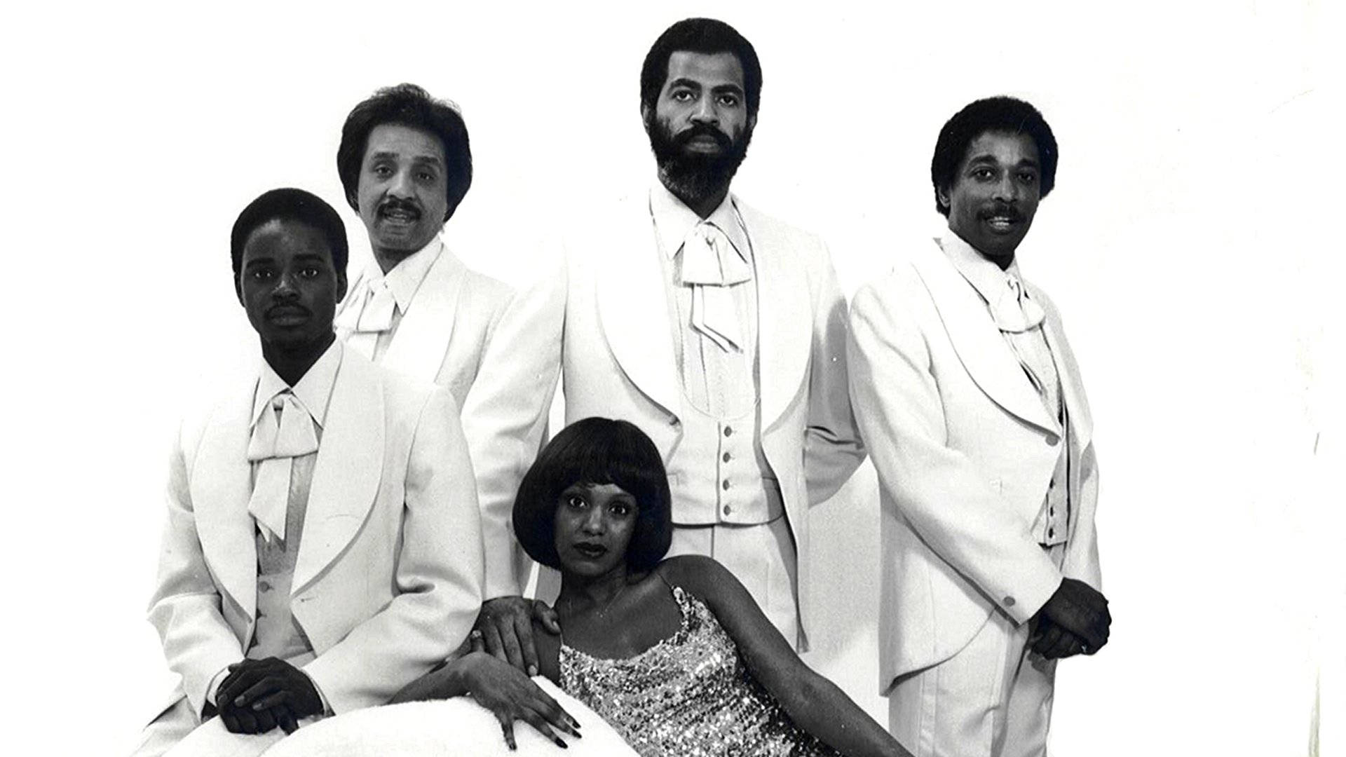 Pla dĩa với thành viên Zola Taylor ở trung tâm Hình nền