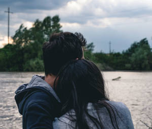 Cặp đôi ôm nhau bên bờ sông