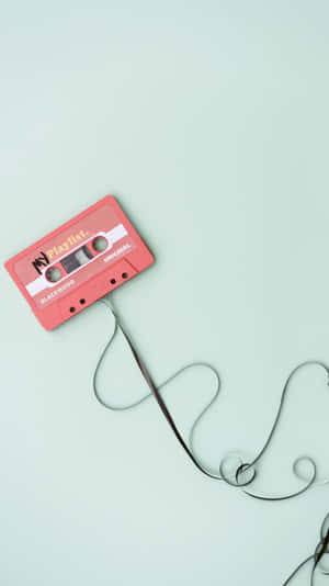 Một cuộn băng cassette được nối với một sợi dây — 美学音乐 Hình nền