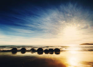 Hình nền bình minh trên Bãi biển Moeraki Boulders